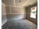 A bedroom under construction with gray walls, white trim, a window and a concrete floor at 18 W Emily Gardens Dr, Selma, NC 27577