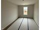 A bright bedroom featuring a neutral color pallete with a single window bringing in natural light at 18 W Emily Gardens Dr, Selma, NC 27577