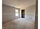 Spacious bedroom featuring natural light from the window and an open doorway at 18 W Emily Gardens Dr, Selma, NC 27577