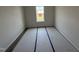 A cozy bedroom featuring vinyl plank floors, neutral walls, a bright window view of the exterior at 18 W Emily Gardens Dr, Selma, NC 27577