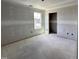 Unfinished bedroom showing drywall, a window, and doorframe at 18 W Emily Gardens Dr, Selma, NC 27577