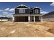 New construction two-story home featuring an attached garage, dark blue siding, and white trim at 18 W Emily Gardens Dr, Selma, NC 27577
