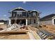 This is the front exterior of a two-story home under construction with a dark blue facade and white trim at 18 W Emily Gardens Dr, Selma, NC 27577