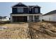 New two-story home featuring an attached two-car garage, a covered front porch, and landscaped yard at 18 W Emily Gardens Dr, Selma, NC 27577
