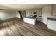 Open kitchen with stainless appliances, a large island, granite countertops, and hardwood floors at 18 W Emily Gardens Dr, Selma, NC 27576