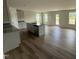 Open kitchen boasts an island with sink and modern grey cabinetry and hardwood flooring at 18 W Emily Gardens Dr, Selma, NC 27576