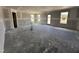 Large unfinished room with lots of natural light from several windows and a glass door at 18 W Emily Gardens Dr, Selma, NC 27577