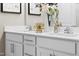 Modern bathroom with double sinks, white cabinets, brushed nickel hardware and decorative accents at 2011 Cross Bones Blvd # 41, Durham, NC 27703
