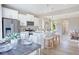 Bright kitchen with white cabinets, stainless appliances, modern lighting and a large island with seating for three at 2011 Cross Bones Blvd # 41, Durham, NC 27703