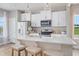 Kitchen featuring white cabinets, stainless appliances, large island with seating, and modern pendant lighting at 2011 Cross Bones Blvd # 41, Durham, NC 27703