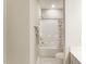 Well-lit bathroom with a shower/tub combination, patterned shower curtain, and towel rack at 205 E Fountainhead Ln # 159, Garner, NC 27529