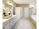 Bright bathroom with marble floors, a large vanity, and a glass-enclosed shower at 205 E Fountainhead Ln # 159, Garner, NC 27529