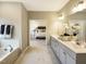 Elegant bathroom featuring double sinks, marble floors, a soaking tub, and access to the bedroom at 205 E Fountainhead Ln # 159, Garner, NC 27529