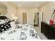 Cozy bedroom with floral bedding, a dresser, and access to a walk-in closet and bathroom at 205 E Fountainhead Ln # 159, Garner, NC 27529