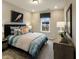 Bright bedroom with a large window, stylish decor, and comfortable bed at 205 E Fountainhead Ln # 159, Garner, NC 27529