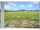 View of spacious backyard with abundant green space under a partly cloudy sky at 21 Trescott St, Smithfield, NC 27577