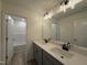 Bathroom featuring double sink vanity with grey cabinets and black fixtures at 21 Trescott St, Smithfield, NC 27577