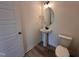 Stylish half bathroom featuring a pedestal sink and modern fixtures at 21 Trescott St, Smithfield, NC 27577