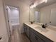 Modern bathroom with double sinks, sleek gray cabinets, and wood-look flooring at 21 Trescott St, Smithfield, NC 27577