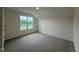 Bedroom featuring neutral carpet, crisp white trim and a large window at 21 Trescott St, Smithfield, NC 27577