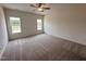 Spacious bedroom with neutral carpet, two windows providing natural light, and a ceiling fan at 21 Trescott St, Smithfield, NC 27577