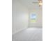A bright bedroom with neutral carpet and a large window at 21 Trescott St, Smithfield, NC 27577