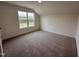 Bright bedroom featuring a large window and plush carpeting at 21 Trescott St, Smithfield, NC 27577