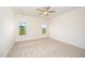 A bright bedroom with neutral carpet and two large windows at 21 Trescott St, Smithfield, NC 27577