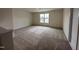 Large bonus room with neutral carpet and a window that provides natural light at 21 Trescott St, Smithfield, NC 27577
