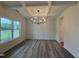 Elegant dining room featuring modern lighting, wainscoting and wood floors at 21 Trescott St, Smithfield, NC 27577