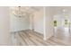 Elegant dining room with hardwood floors, chandelier, and paneled wall at 21 Trescott St, Smithfield, NC 27577