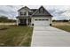 Inviting two-story home with a two-car garage, neutral siding, and a well-manicured front yard at 21 Trescott St, Smithfield, NC 27577