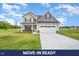 Charming two-story home with a manicured lawn and attached two-car garage at 21 Trescott St, Smithfield, NC 27577