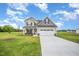 Inviting two-story home with a well-maintained lawn, perfect for outdoor enjoyment at 21 Trescott St, Smithfield, NC 27577