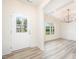 Welcoming entryway with hardwood flooring, chandelier and natural light streaming through window at 21 Trescott St, Smithfield, NC 27577