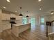 Open kitchen with stainless appliances, kitchen island and view of the living room at 21 Trescott St, Smithfield, NC 27577
