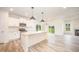 Bright, open kitchen features a center island, granite counters, and stainless steel appliances at 21 Trescott St, Smithfield, NC 27577