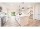 Bright, open kitchen features a center island, granite counters, and stainless steel appliances at 21 Trescott St, Smithfield, NC 27577