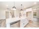 An open kitchen features a large island with a sink and stainless steel appliances at 21 Trescott St, Smithfield, NC 27577