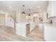An open kitchen features a large island with a sink and stainless steel appliances at 21 Trescott St, Smithfield, NC 27577