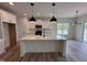 Modern kitchen with white cabinetry, granite countertops, stainless steel appliances, and pendant lighting at 21 Trescott St, Smithfield, NC 27577