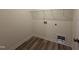 Bright laundry room with built in shelving and wood-style flooring at 21 Trescott St, Smithfield, NC 27577
