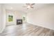 Spacious living room with fireplace, large windows and modern ceiling fan at 21 Trescott St, Smithfield, NC 27577