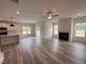 Open-concept living room features a fireplace, ceiling fan, and seamless access to the kitchen at 21 Trescott St, Smithfield, NC 27577