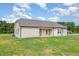 The side of the home features a covered patio and an expansive backyard at 210 Maxwell Farm Ln, Selma, NC 27576