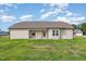 An open backyard with a covered patio and green space at 210 Maxwell Farm Ln, Selma, NC 27576