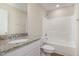 White bathroom with tub, granite countertop and white cabinetry at 210 Maxwell Farm Ln, Selma, NC 27576