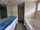 Bright bathroom with dual sinks, a soaking tub, and modern fixtures, offering a luxurious and relaxing experience at 210 Maxwell Farm Ln, Selma, NC 27576