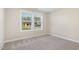 Cozy bedroom with plush carpeting and bright window, offering a comfortable retreat with natural light at 210 Maxwell Farm Ln, Selma, NC 27576