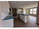 Well-lit kitchen with an island, white cabinets, and stainless steel appliances, ready for culinary adventures at 210 Maxwell Farm Ln, Selma, NC 27576